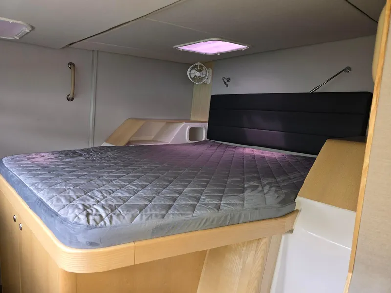 Slide: The Image of 2025 Seawind 1370 cabin interior with a comfortable bed and modern design. - 27