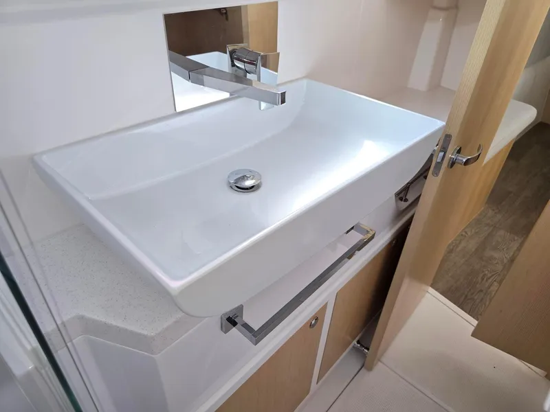Slide: The Image of Modern bathroom sink in 2025 Seawind 1370 yacht, featuring sleek design and chrome fixtures. - 28