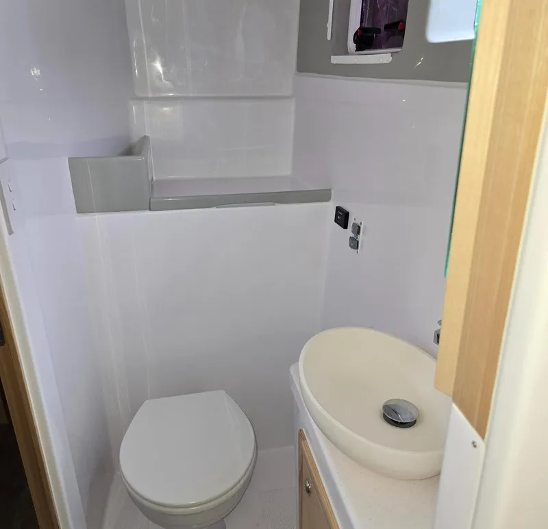 Slide: The Image of Modern bathroom in 2025 Seawind 1370 yacht, featuring sleek sink and compact toilet. - 30