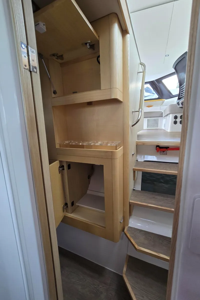 Slide: The Image of Interior of 2025 Seawind 1370 yacht with wooden cabinetry and stairs. - 33
