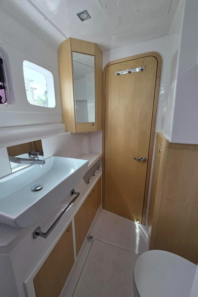 Slide: The Image of Modern bathroom in 2025 Seawind 1370 yacht, featuring sleek sink, mirror, and wooden accents. - 35