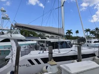 Slide: The Image of 2025 Seawind 1370 catamaran docked at marina under clear blue sky. - 36