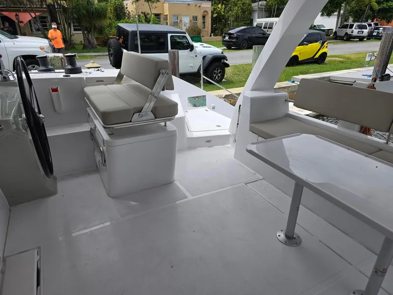 Slide: The Image of 2025 Seawind 1370 yacht cockpit with seating, steering wheel, and outdoor table. - 7