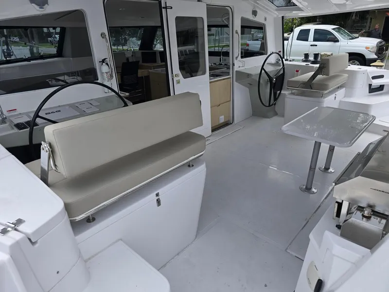 Slide: The Image of 2025 Seawind 1370 yacht interior with seating, steering wheels, and table. - 8