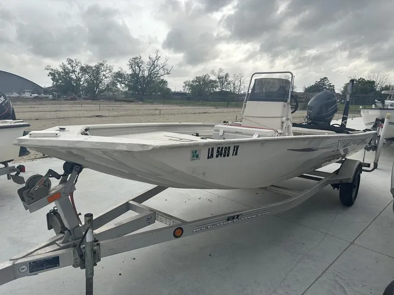 Slide: The Image of 2011 Xpress 18 cc boat on trailer under cloudy sky. - 4