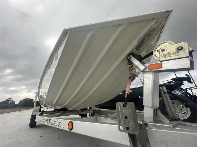 Slide: The Image of 2011 Xpress 18 cc boat on trailer under cloudy sky. - 7