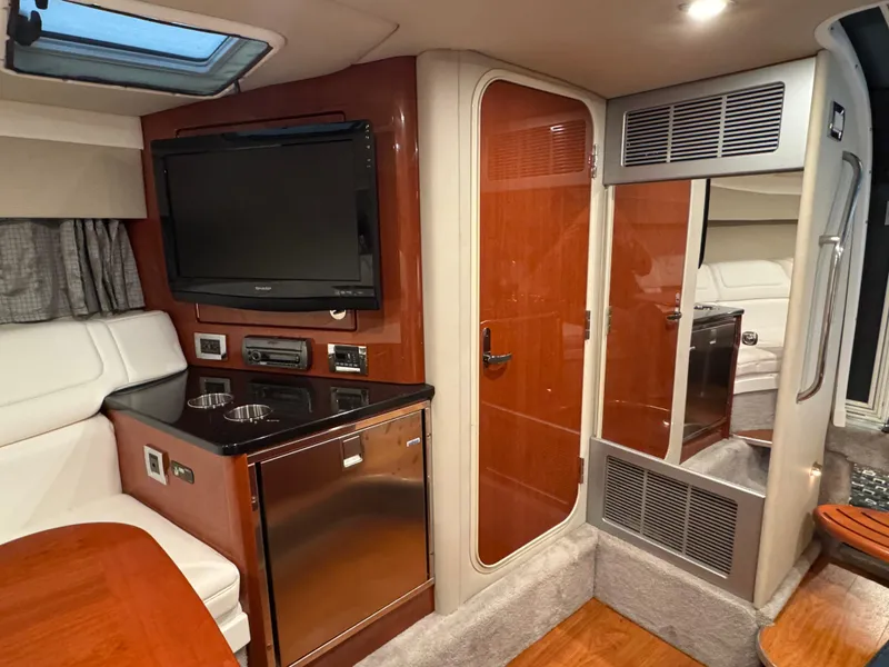 Slide: The Image of Interior of 2011 Formula 350 Sun Sport with TV, fridge, and wood accents. - 16