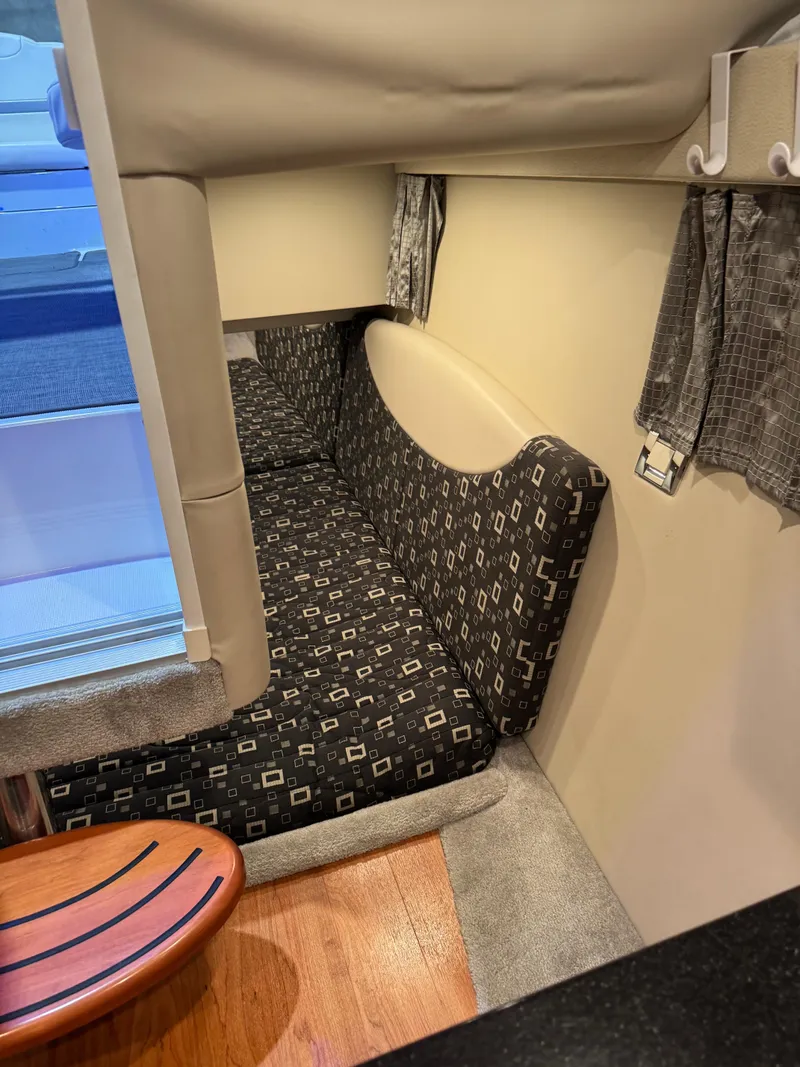 Slide: The Image of Interior cabin of a 2011 Formula 350 Sun Sport boat with patterned seating and wooden flooring. - 18