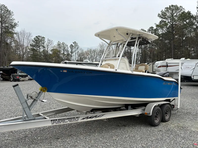 Slide: The Image of 2017 Key West 219fs boat on trailer, blue hull, parked outdoors. - 1
