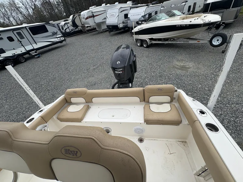 Slide: The Image of 2017 Key West 219fs boat interior with seating, parked in a lot with RVs and trailers. - 11