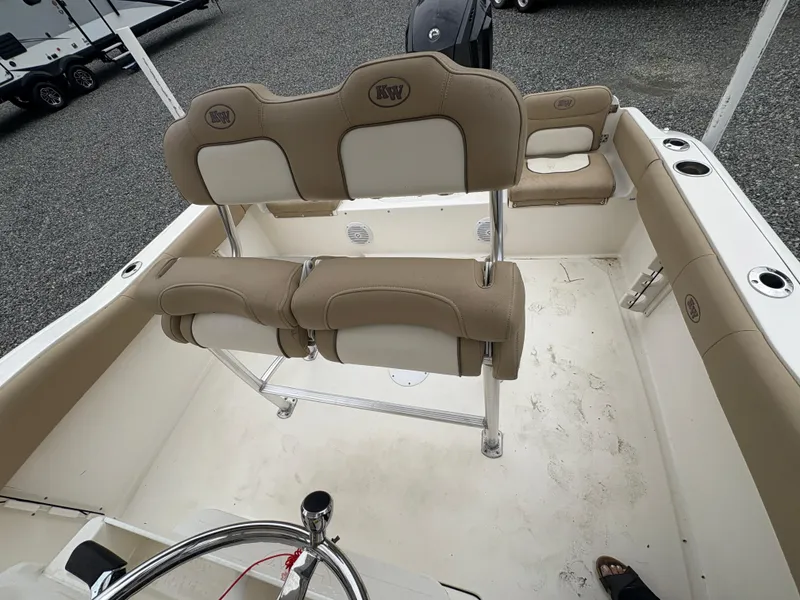 Slide: The Image of 2017 Key West 219fs boat interior with beige seating and steering wheel. - 12