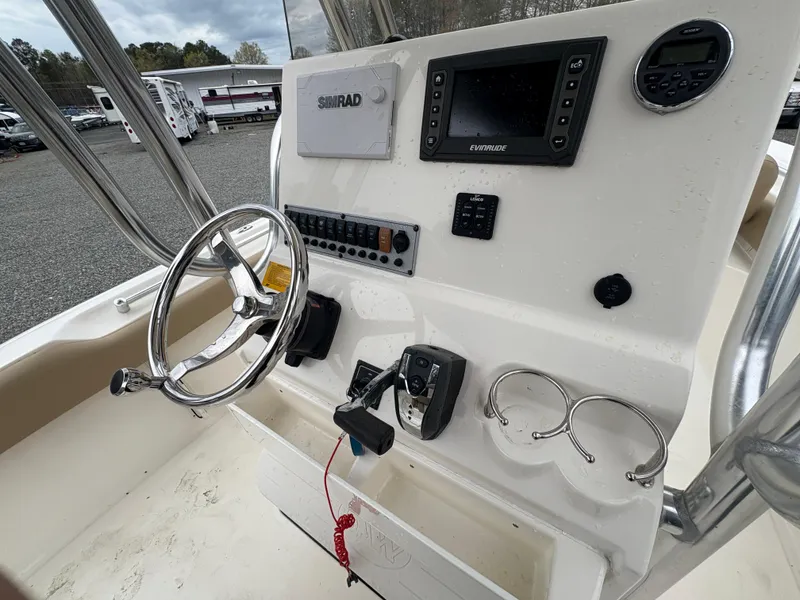 Slide: The Image of 2017 Key West 219fs boat console with steering wheel, controls, and navigation equipment. - 14