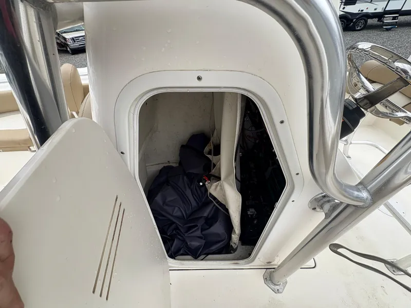 Slide: The Image of 2017 Key West 219fs boat storage compartment with open door and gear inside. - 16