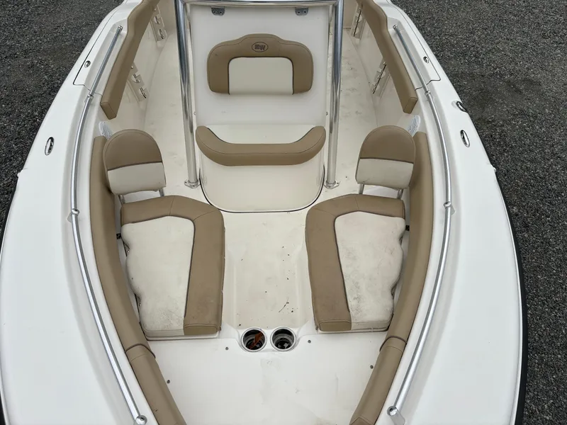 Slide: The Image of 2017 Key West 219fs boat interior with beige seating and white deck. - 18
