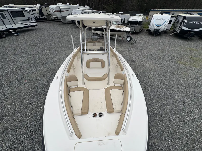 Slide: The Image of 2017 Key West 219fs boat with beige seating, parked among RVs on gravel. - 19