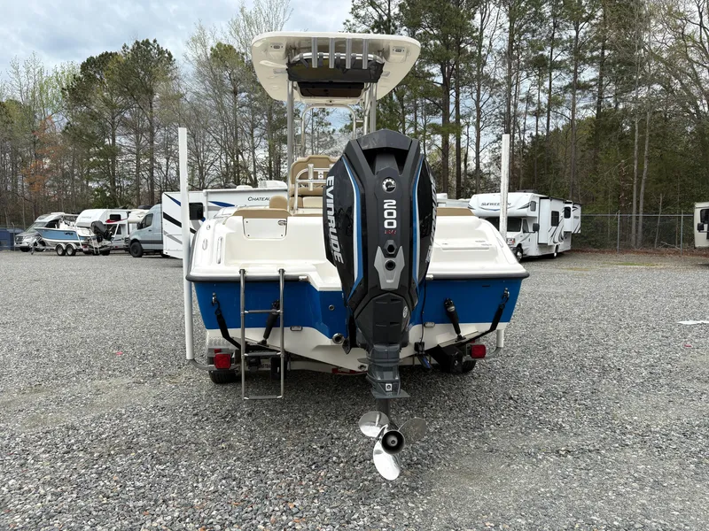 Slide: The Image of 2017 Key West 219fs boat with Evinrude 200 engine, parked in a gravel lot. - 3