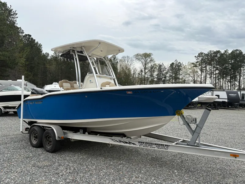 Slide: The Image of 2017 Key West 219fs boat on trailer, blue hull, parked outdoors. - 5