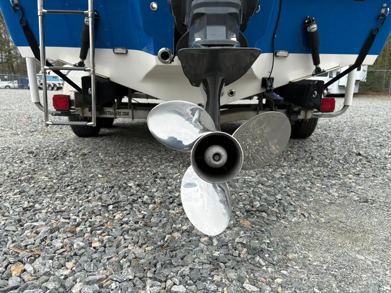 Slide: The Image of Rear view of a 2017 Key West 219fs boat showing the propeller and motor. - 7