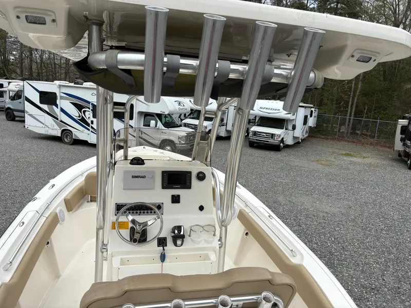 Slide: The Image of 2017 Key West 219fs boat interior with steering console, parked near RVs. - 9