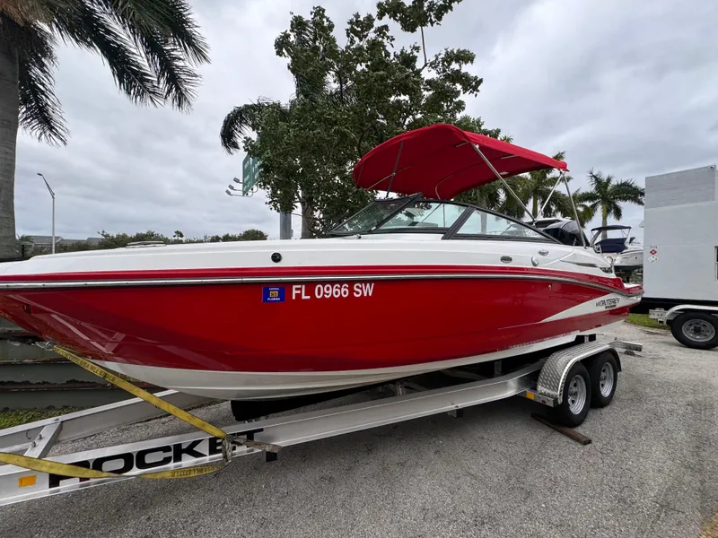 Slide: The Image of Red 2020 Monterey M-45 boat on trailer with palm trees in background. - 1