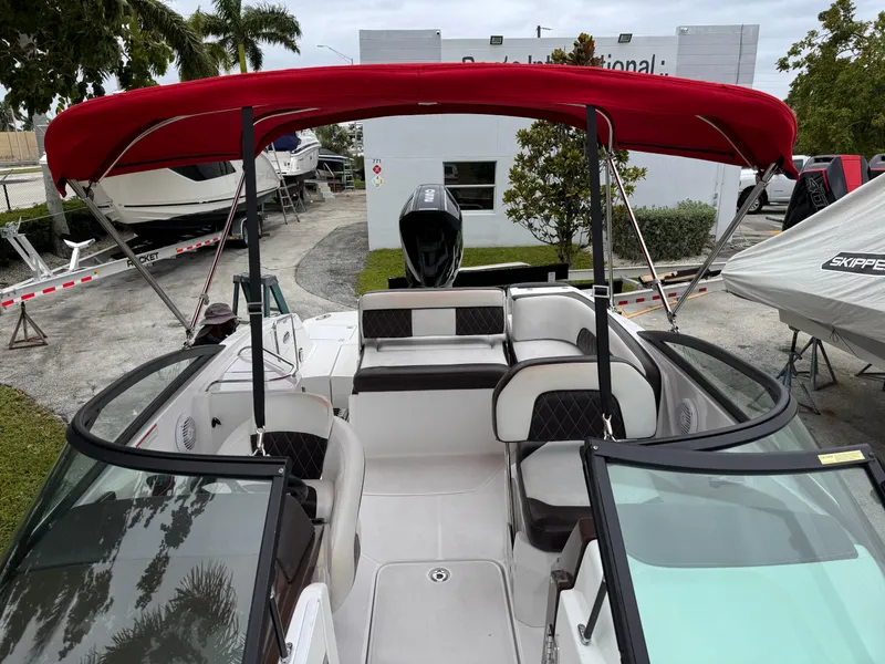Slide: The Image of 2020 Monterey M-45 boat with red canopy, spacious seating, and modern design. - 14