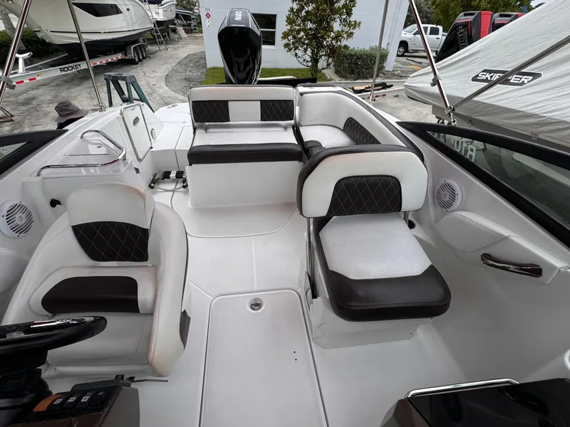 Slide: The Image of 2020 Monterey M-45 boat interior with white and black seating, docked near other boats. - 16
