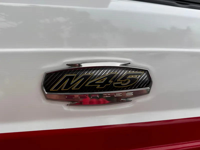 Slide: The Image of 2020 Monterey M-45 emblem on white and red surface. - 4