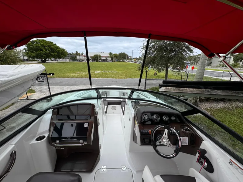 Slide: The Image of Interior view of 2020 Monterey M-45 boat with red canopy and modern dashboard. - 6