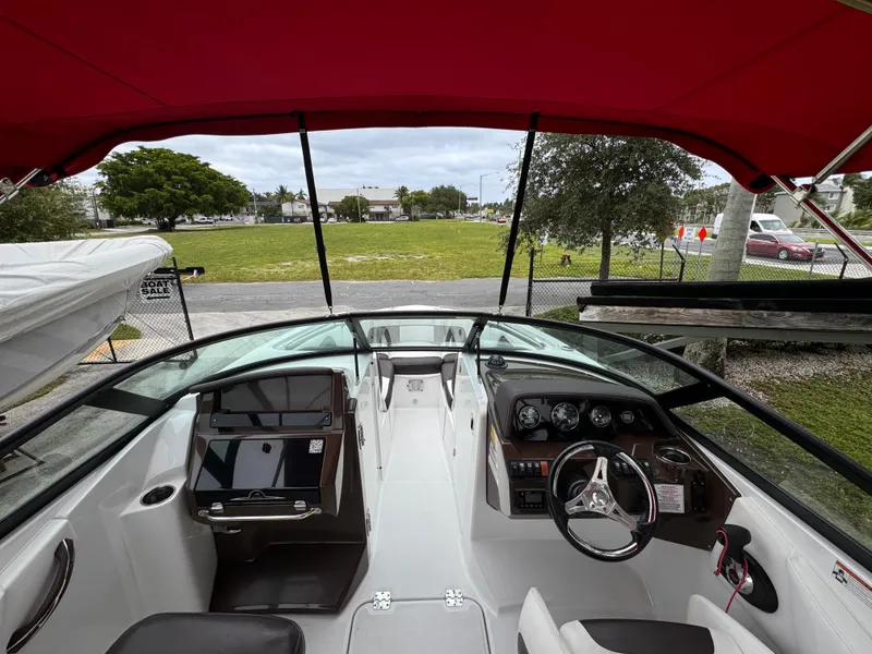 Slide: The Image of Interior view of 2020 Monterey M-45 boat with red canopy and modern dashboard. - 7
