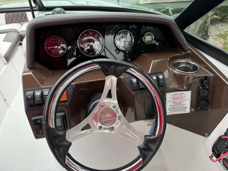 Slide: The Image of Steering wheel and dashboard of 2020 Monterey M-45 boat with gauges and controls. - 8