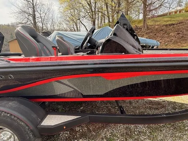Slide: The Image of 2018 Nitro Z18 boat with sleek red and black design, parked outdoors. - 1