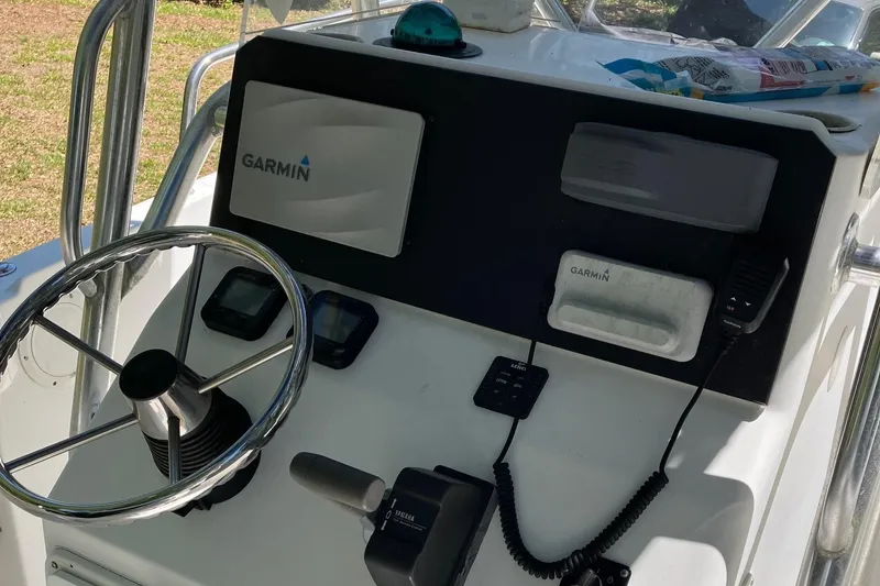 Slide: The Image of Edgewater 225CC 2002 boat console with Garmin navigation system and steering wheel. - 4