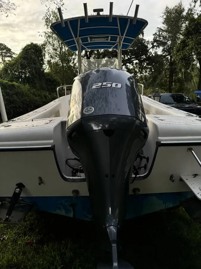 Slide: The Image of 2002 Edgewater 225CC boat with a 250 horsepower engine, parked outdoors. - 7