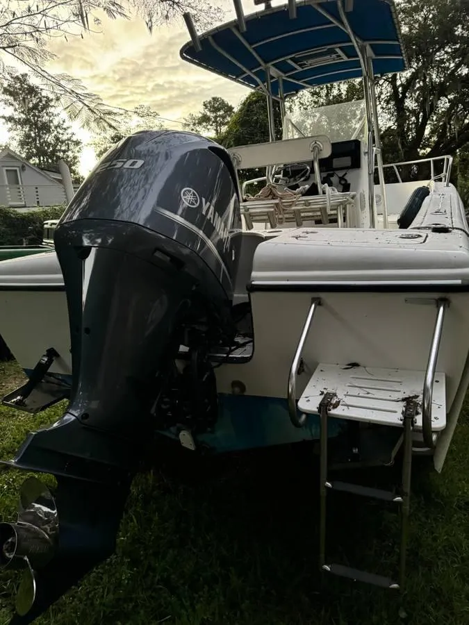 Slide: The Image of 2002 Edgewater 225CC boat with Yamaha outboard motor and blue canopy. - 8