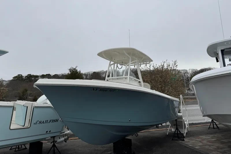 The Image of 2024 Sailfish 220 CC boat displayed outdoors on a cloudy day. - 0