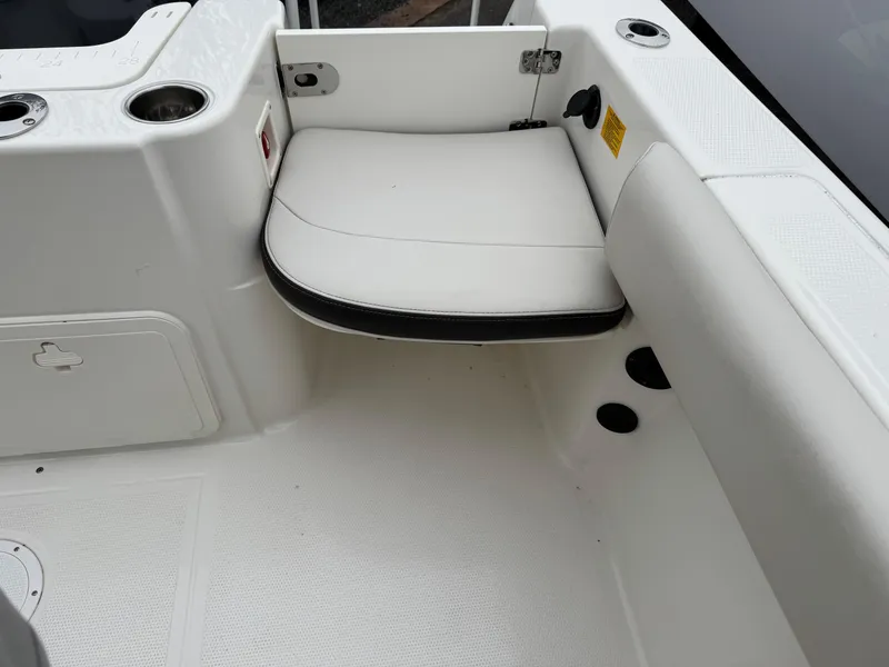 Slide: The Image of 2024 Sailfish 220 CC boat interior with white seating and storage compartments. - 13