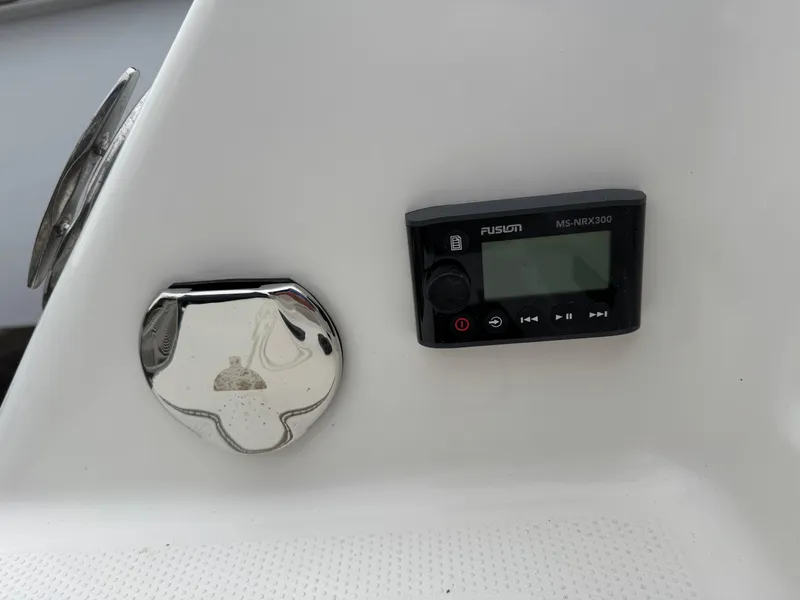 Slide: The Image of 2024 Sailfish 220 CC boat console with Fusion MS-NRX300 stereo control. - 19