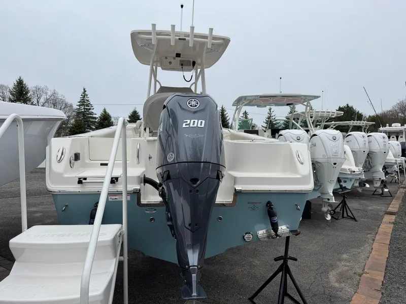 Slide: The Image of 2024 Sailfish 220 CC boat with Yamaha 200 engine displayed outdoors. - 2