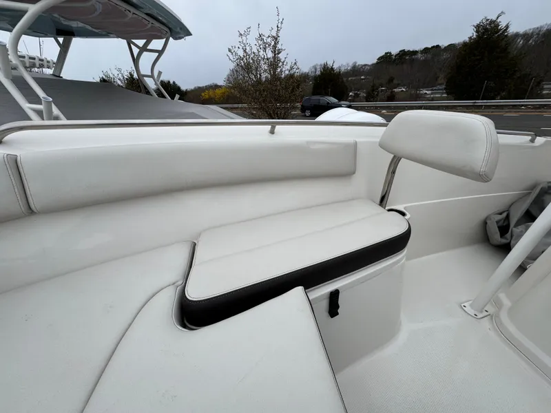 Slide: The Image of 2024 Sailfish 220 CC boat interior with white seating and sleek design. - 4