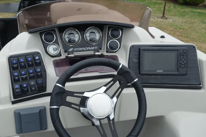 Slide: The Image of 2021 Starcraft SLS 5 DC boat dashboard with steering wheel and control panel. - 10