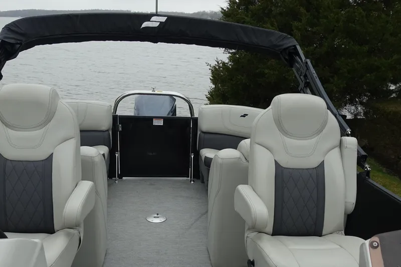 Slide: The Image of 2021 Starcraft SLS 5 DC boat interior with plush seating, overlooking a serene lake. - 14