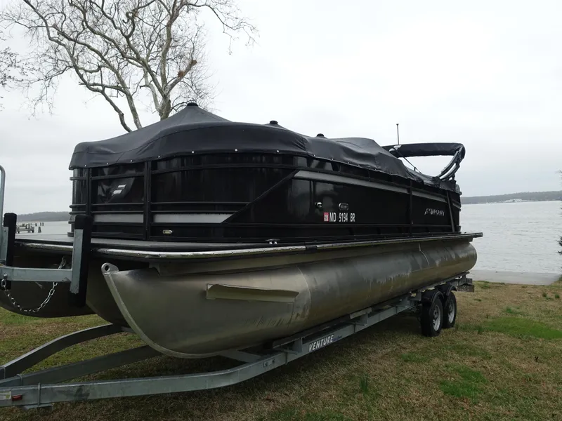 Slide: The Image of 2021 Starcraft SLS 5 DC pontoon boat on trailer by a lake. - 3