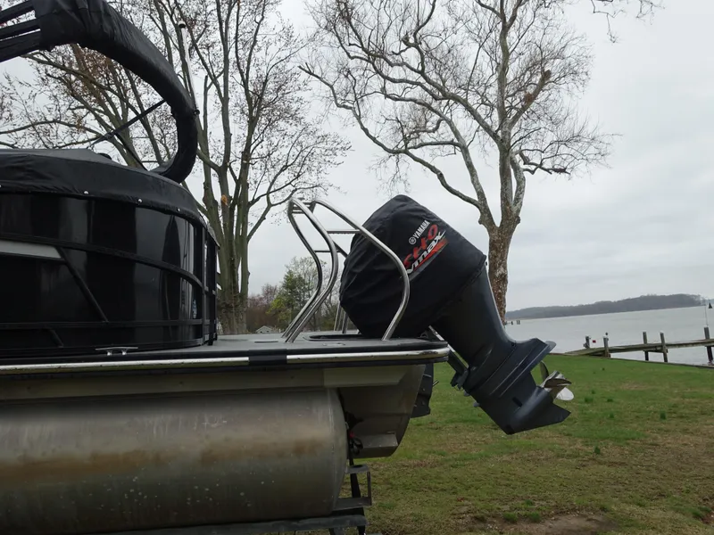 Slide: The Image of 2021 Starcraft SLS 5 DC pontoon boat with outboard motor, lakeside view. - 4