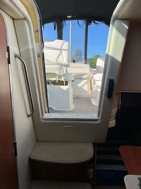 Slide: The Image of Interior view of 2009 Bayliner 245 Cruiser, showing cabin entrance and seating area. - 16