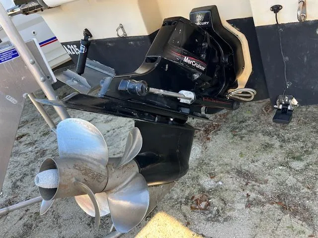 Slide: The Image of 2009 Bayliner 245 Cruiser with MerCruiser outdrive and propeller on sandy ground. - 3