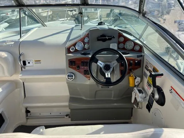 Slide: The Image of 2009 Bayliner 245 Cruiser helm with steering wheel and instrument panel. - 7