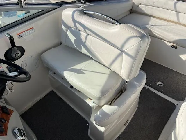Slide: The Image of 2009 Bayliner 245 Cruiser interior with white seating and steering wheel. - 8