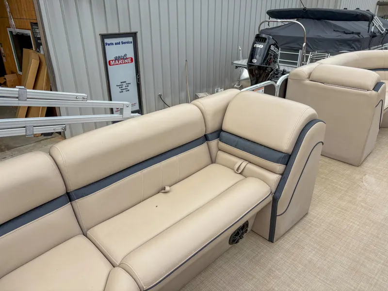 Slide: The Image of 2018 Trifecta 22 C CS 2.75 pontoon boat with beige seating and storage compartments. - 15