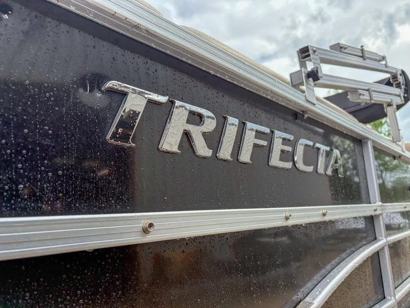 Slide: The Image of 2018 Trifecta 22 C CS 2.75 boat with sleek black exterior and chrome lettering. - 3