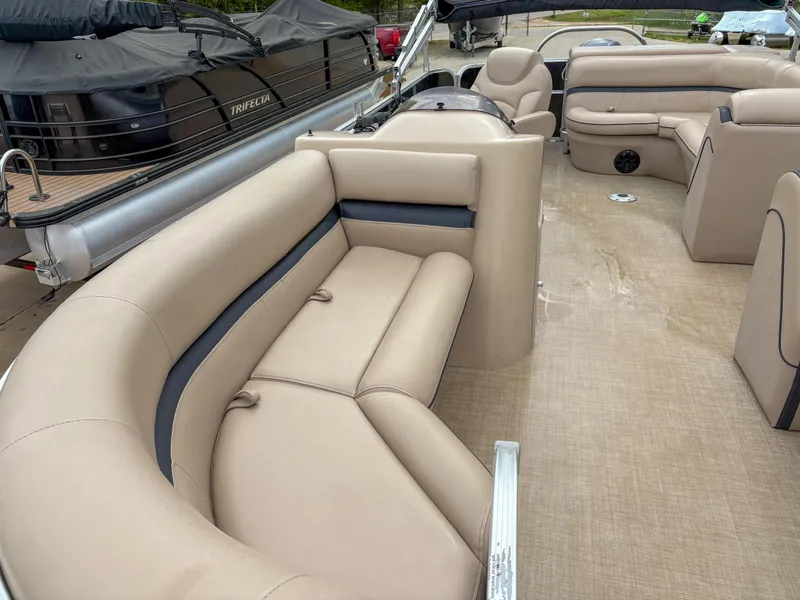 Slide: The Image of Luxurious 2018 Trifecta 22 C CS 2.75 pontoon boat with spacious beige seating. - 9